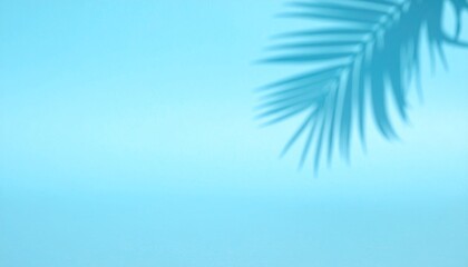 Obraz premium Tropical palm tree branches with green foliage sway in the wind against a blue summer sky background reflecting a sunny nature design