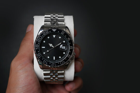Luxury Stainless Steel Automatic Watch with Black Dial and Date Display in Hand
