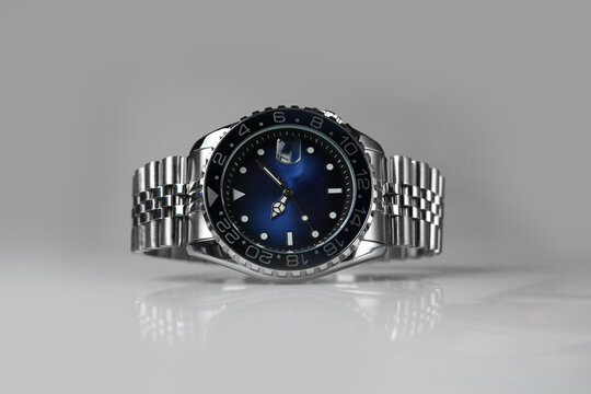 Luxury Stainless Steel GMT Watch with Blue Dial Isolated on Gray Background