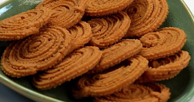 Chakli is a savoury snack from India. It is a spiral shaped snack with a spiked surface