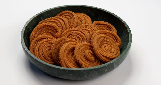 Chakli is a savoury snack from India. It is a spiral shaped snack with a spiked surface