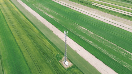 Internet signal tower over green fields