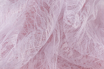 Beautiful abstract background of flowing white airy fabric. soft waves of openwork white transparent guipure. Top view. Wedding concept.