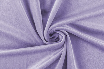delicate soft folds of purple velvet fabric. Twisted velvet material in a spiral. beautiful background. layout for design. top view.