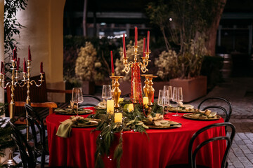 Elegant decor for Christmas family dinner. Center piece vintage chandelier with candles.