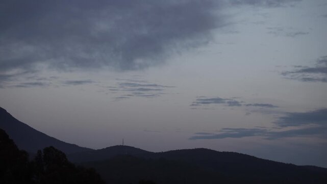 peaceful dawn timelapse of slow moving clouds over hills in tasmania australia