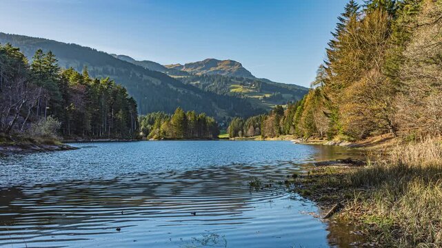 Time lapse, lake surrounded by the mountains. Lake Chapfensee, Hydroelectric reservoir high in the mountains. Mels, Canton of St. Gallen, Switzerland.