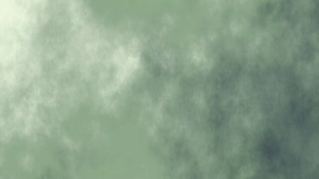 Hazy green sky with light and dark patches. Great for nature themed designs or background elements in artistic projects.