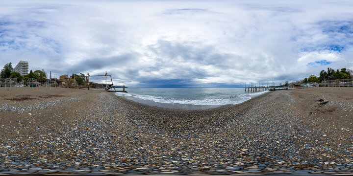 A seamless spherical HDRI panorama, a 360-degree view of a sandy beach by the sea on a cloudy summer day with beautiful clouds in equirectangular projection, VR content. Sea beach panorama.