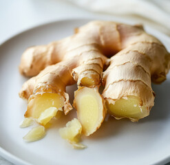 Fermented Ginger Shot Served With Fresh Ginger Root On White Plate
