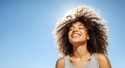 African woman breathing calmly under blue sky