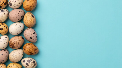 Colorful quail eggs arranged on a blue background for decoration or art project