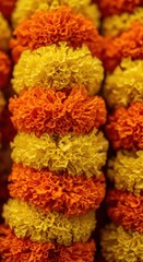 Close up of marigold flower garlands in orange and yellow, used for indian celebrations.