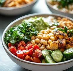 Ancient Grain Power Bowl With Chickpeas, Cucumber, And Fresh Greens On White Plate
