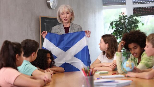 in geography lesson, elderly teacher very eloquently tells children about history of ancient scotland. High quality 4k footage