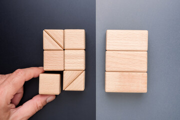 Wooden blocks arranged in two different ways, representing how the same resources can create inefficiency or efficiency depending on the structure execution, and system design in business operations