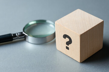 Question mark block with magnifying glass for analysis and decision making