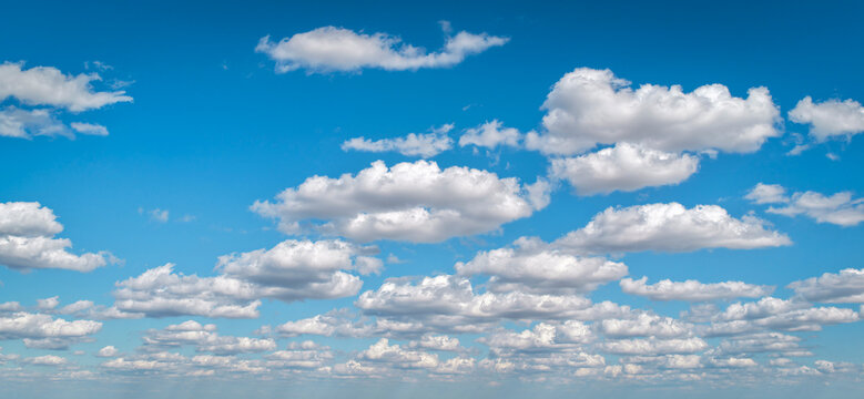 Morning blue sky with clouds layers. Cloudy sky background. Calm cloudscape with white clouds background. Puffy cumulus clouds pattern. Blue sky backdrop. Calm cloud background.