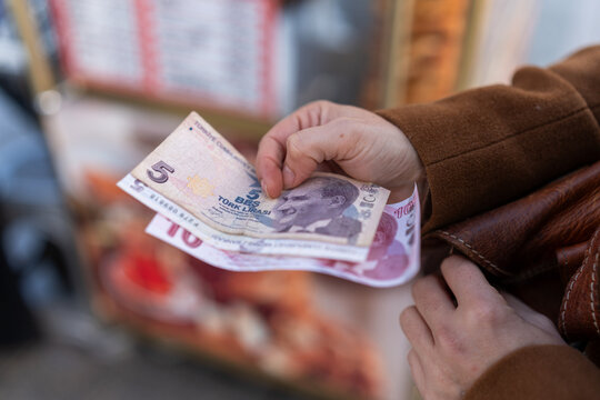 Hand holding turkish lira banknotes for tourism expenses