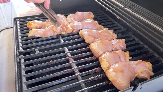 Juicy Chicken Thighs Being Grilled to Perfection on a Small Weber Grill