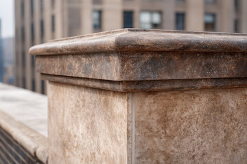 Naklejka premium Masonry parapet coping stone urban architecture rooftop weathered detail stone texture