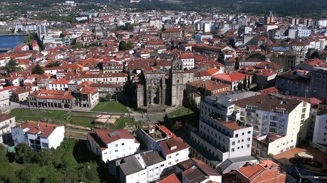Sow drone pull-out (zoom out) shot focuses on the detailed facade of the Basilica of Santa Mar&iacute;a la Mayor in Pontevedra, Galicia, Spain