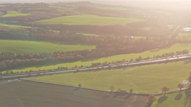 Drone flyover tracks along the busy M1 Motorway (a major UK national highway) as it slices through the countryside near the Yorkshire Sculpture Park in West Yorkshire.
