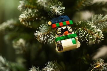 Fototapeta premium Poland, Warsaw. December 1, 2025. New Year's toy snowman made of Lego on a Christmas tree branch.