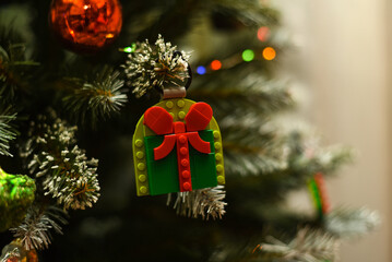 Fototapeta premium A Lego Christmas gift on a Christmas tree branch.