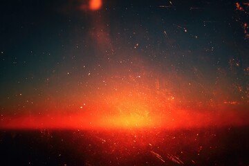Vivid orange glow over a dark horizon line, textured with specks and scratches