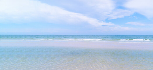 Beautiful tropical beach with clear blue sea and sky, clean banner background with copy space