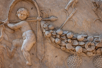 An ancient bas-relief on a marble surface. Antique carvings depicting fabulous creatures. the surface of the stone. Ancient Greek myths in marble. Ruins of an ancient city.