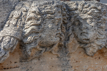 An ancient bas-relief on a marble surface. Antique carvings depicting fabulous creatures. the surface of the stone. Ancient Greek myths in marble. Ruins of an ancient city.