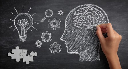 Brain, ideas and creative thinking concept on blackboard.