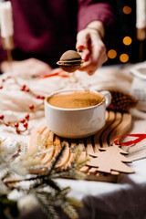 Female hands adding cocoa powder to a warm drink. Cozy winter beverage preparation with festive...