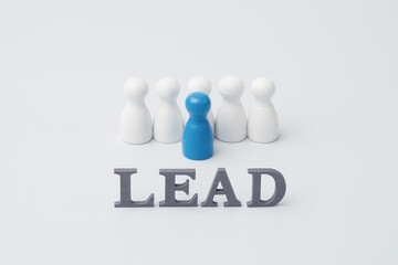 Leadership and leading the team concept with leader figure and lead text