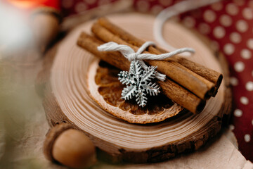 Warm winter flat lay with cinnamon sticks and rustic Christmas decor. Cozy handmade mood and festive seasonal atmosphere.