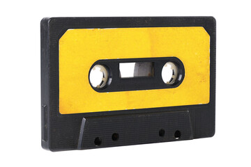 Obraz premium Old yellow cassette tape with music tracks from the past isolated on white background.