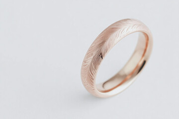 Extreme close-up of a ring with intricate engraving, focusing on metal texture and detailed patterns, soft side lighting, gentle highlights and shadows, blurred neutral background