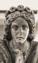 Very Old Statue of an Angelic Face before a Church in Black and White. High quality photo