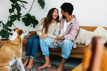 Good company: A couple laughing together while their dog watches