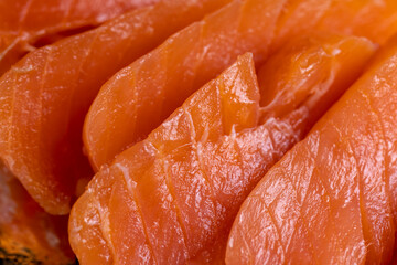 lightly salted fresh trout cut into pieces on the table, fresh trout or salmon with salt and spices without cooking