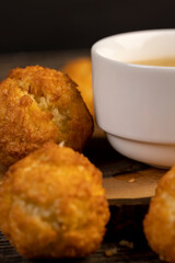 sweet cookies with coconut pieces are on the table, a group of sweet freshly made cookies for a tea party, a white cup filled with hot tea