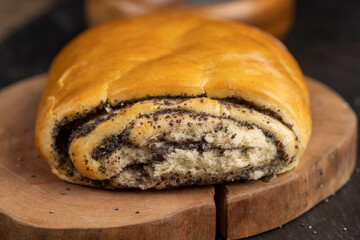 fresh wheat bun with lots of poppy , soft bun with poppy seeds on the table