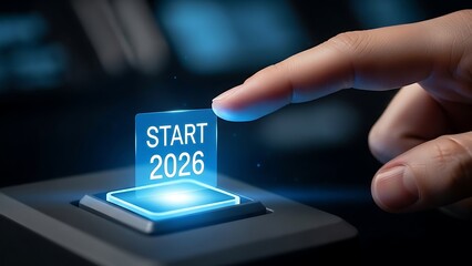 Finger pressing a glowing start button for the year 2026
