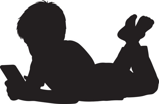 Silhouette of a young boy lying on his stomach looking at a smartphone in his hands representing modern childhood technology use and leisure activities also transparent background