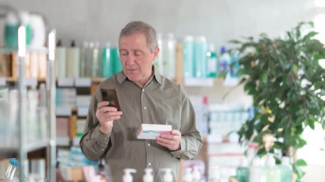 Focused elderly man in pharmacy scanning barcode on box of pills with smartphone, carefully checking dosage, side effects, or contraindications before purchase, ensuring safe self-medication