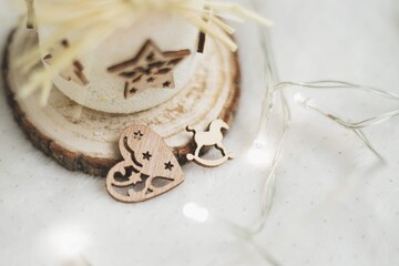Handmade frosted candle holder with wooden star and heart ornaments on white background