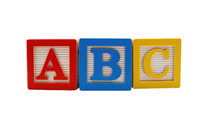 Three colorful alphabet blocks (A, B, C) isolated against a solid black background in a horizontal line