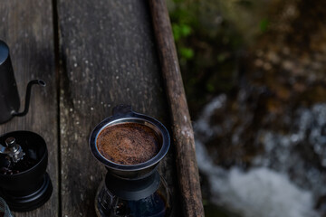 drip coffee set on the wood terrace at the coffee shop next to freshness small river stream